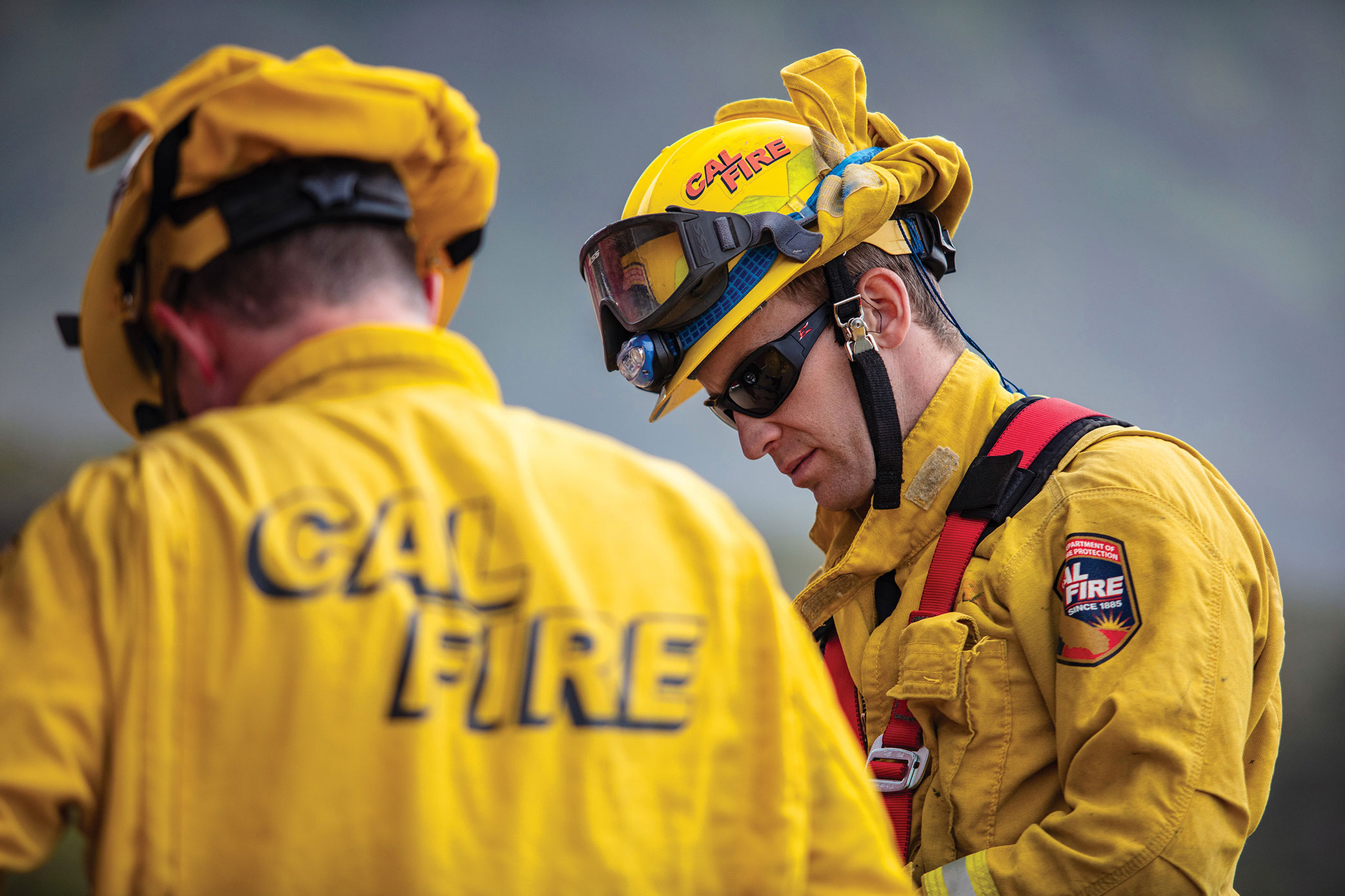 Two CAL Fire firefighters responding on a call
