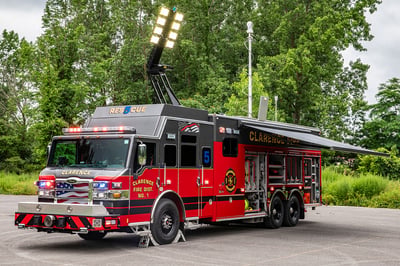 The front drivers side of a Velocity Combination Heavy-Duty Rescue fire truck with the awning, light tower and mast extended.