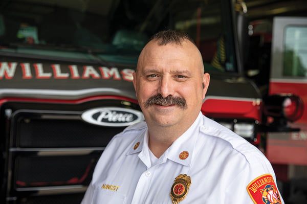 The fire chief of the Williamsport Fire Department in Pennsylvania posed in front of a fire truck.