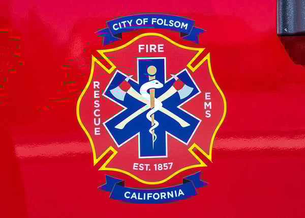 The logo for Folsom Fire Department on the officers door of a Pierce Velocity fire truck.-1