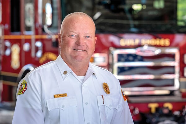 The fire chief of Gulf Shores Fire Department in Alabama posed in front of a fire truck.
