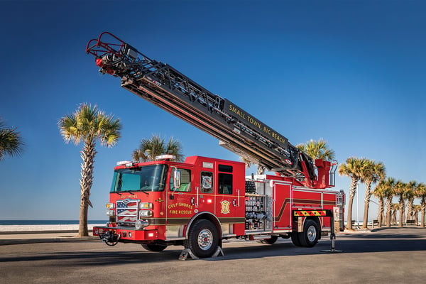 An Ascendant 107 Heavy Duty Aerial Ladder - Single Rear Axle parked by a beach with the aerial up.