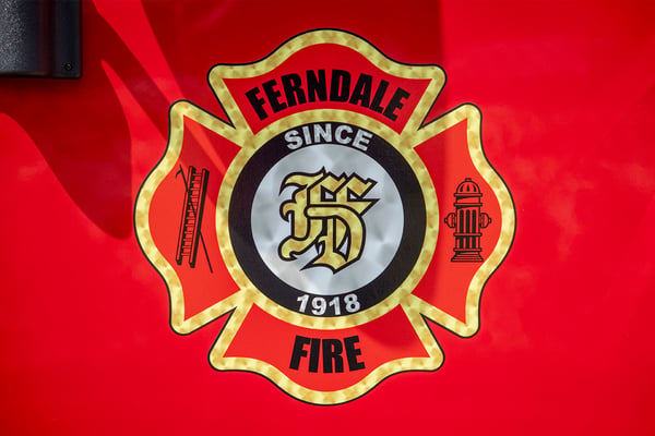 A maltese cross graphic on the door of a fire truck for Fernale Fire Department in Michigan.