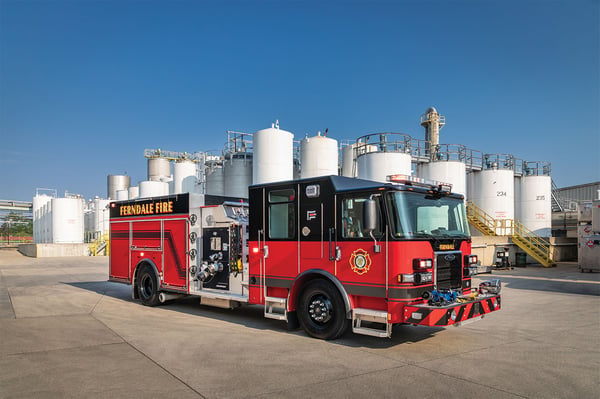 Thumbnail The front officers side of a Saber Pumper fire truck parked in front of a chemical plant on a sunny day.