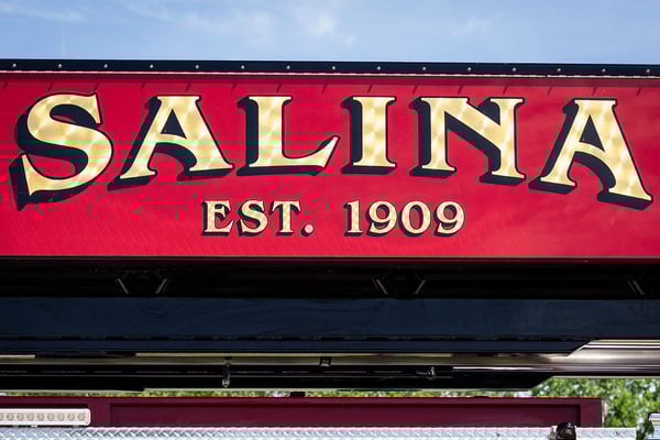 A gold leaf graphic on the side of an aerial fire truck for Salina Fire Department in Kansas.