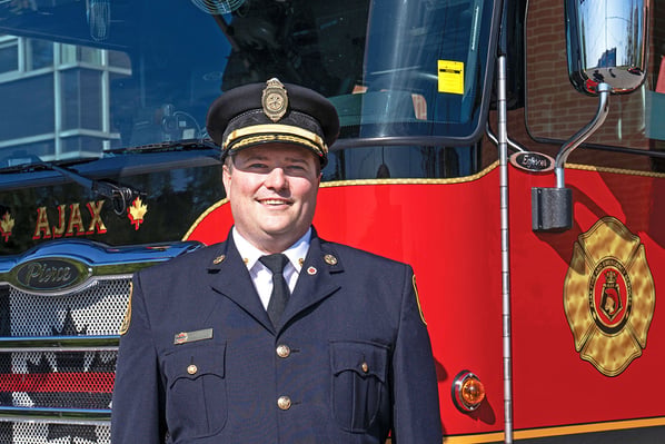 The fire chief of Ajax Fire & Rescue Services in Ontario, Canada posed in front of a fire truck.
