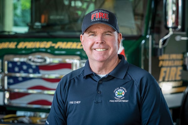 The fire chief for Coral Springs Parkland Fire Rescue in Florida posed in front of a fire truck.