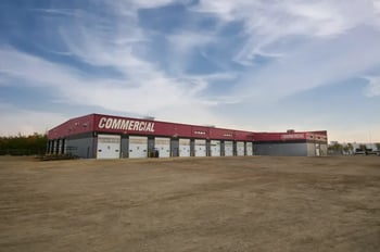 Exterior view of the Commercial Emergency Equipment service center in Edmonton, Alberta, showing numbered bay doors.