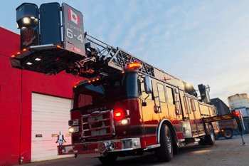 Canadian Pierce fire truck Tower 6-4, delivered by Commercial Emergency Equipment, parked at a fire station.