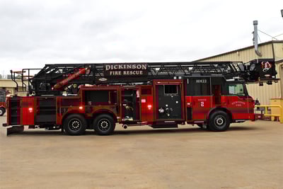Fire truck compartments open on the driver side displaying tool storage.
