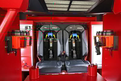 Interior of the fire apparatus showing seating and mounted SCBA air packs.