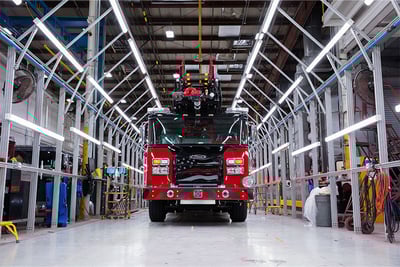 A red and black fire truck in the light tunnel during final testing and checks.