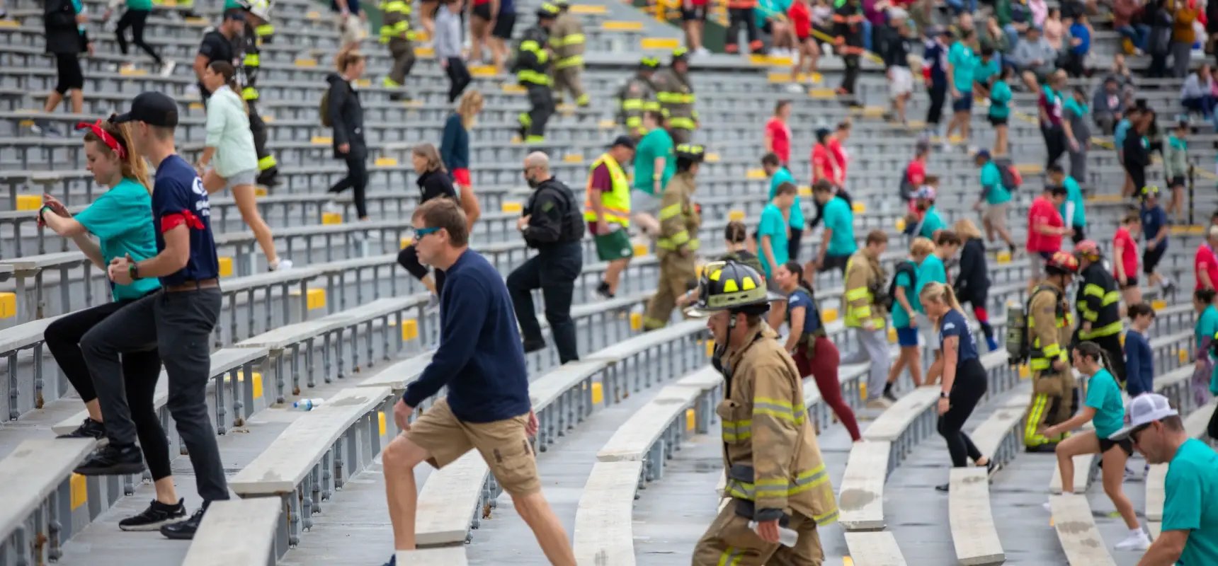 Participants and firefighters climb stadium stairs during the annual 9/11 Memorial Stair Climb.