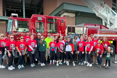 Participants pose in front of a fire engine at the Lambeau Field 9/11 Memorial Stair Climb.