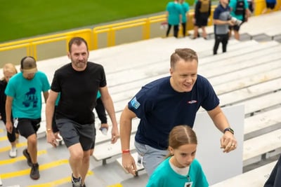 Participants climb the stadium steps of Lambeau Field during a 9/11 Memorial Stair Climb event.