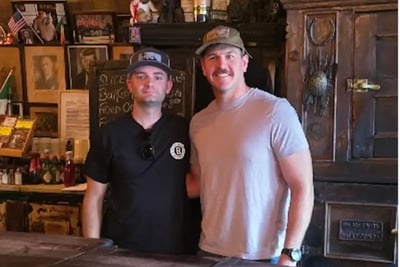 Fire Captain Will Holt and Aric Tegtmeier smile together during their first in-person meeting.