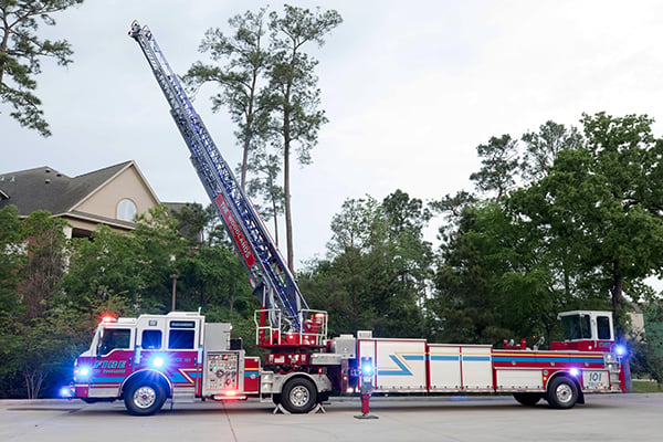 Pierce Ascendant 107' Heavy-Duty Tiller Aerial Ladder Fire Truck parked outside with ladder fully extended into the air. 