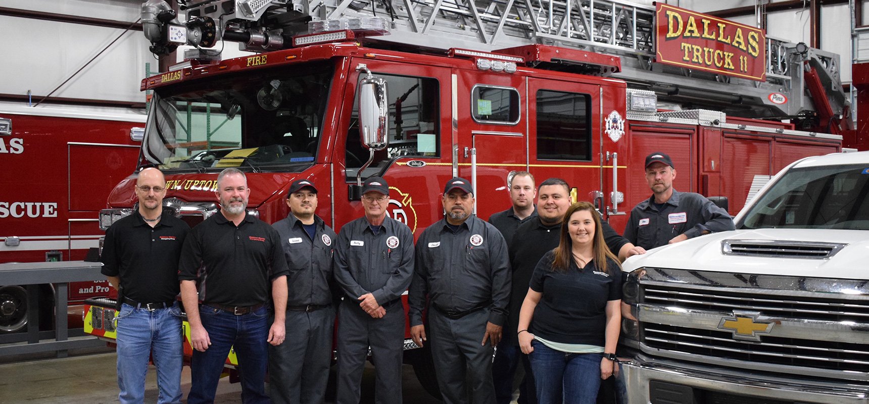 Siddons-Martin Emergency Group employees stand in front of a fire truck at one of the companies three new service centers.