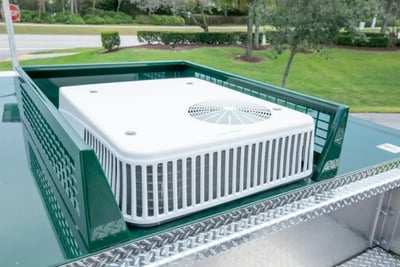 A white rooftop HVAC unit installed on a fire truck for climate control in extreme regional weather.