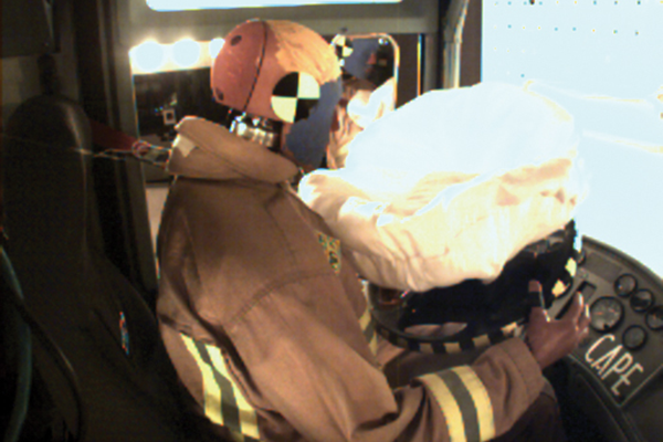 A dummy sitting in the front driver’s side seat of a Pierce Fire Truck with an airbag for Safety testing. 