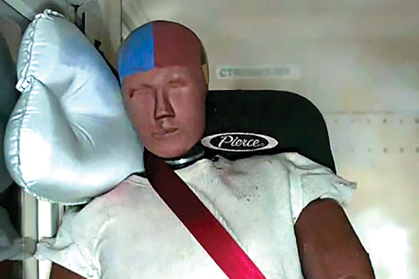A dummy in the front officer’s side of a Pierce Fire Truck with a side airbag for Safety testing. 