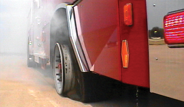 Pierce Fire Truck parked outside in a parking lot with a flat tire. 