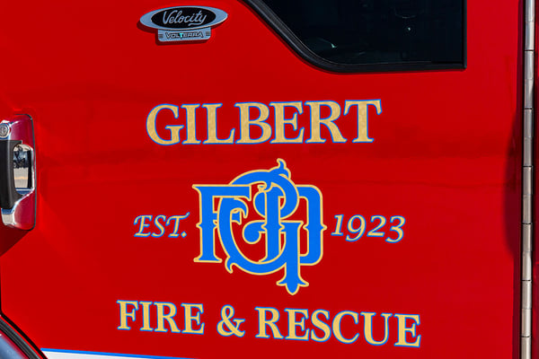 The officers door on a Pierce Volterra fire truck with Gilbert Fire & Rescues graphics on it.