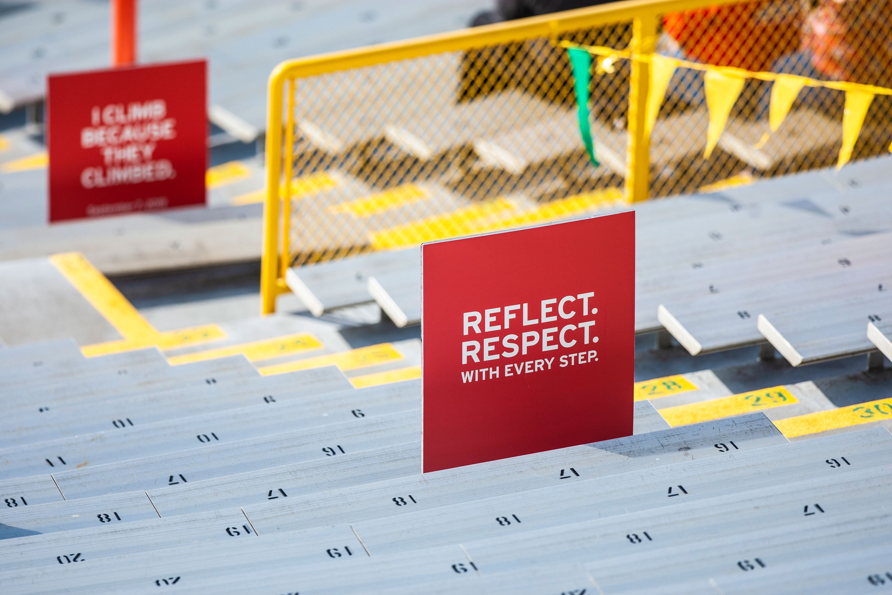 9/11 timeline signs along the bleachers of Lambeau Field at the Pierce Manufacturing 9/11 Memorial Stair Climb Event.