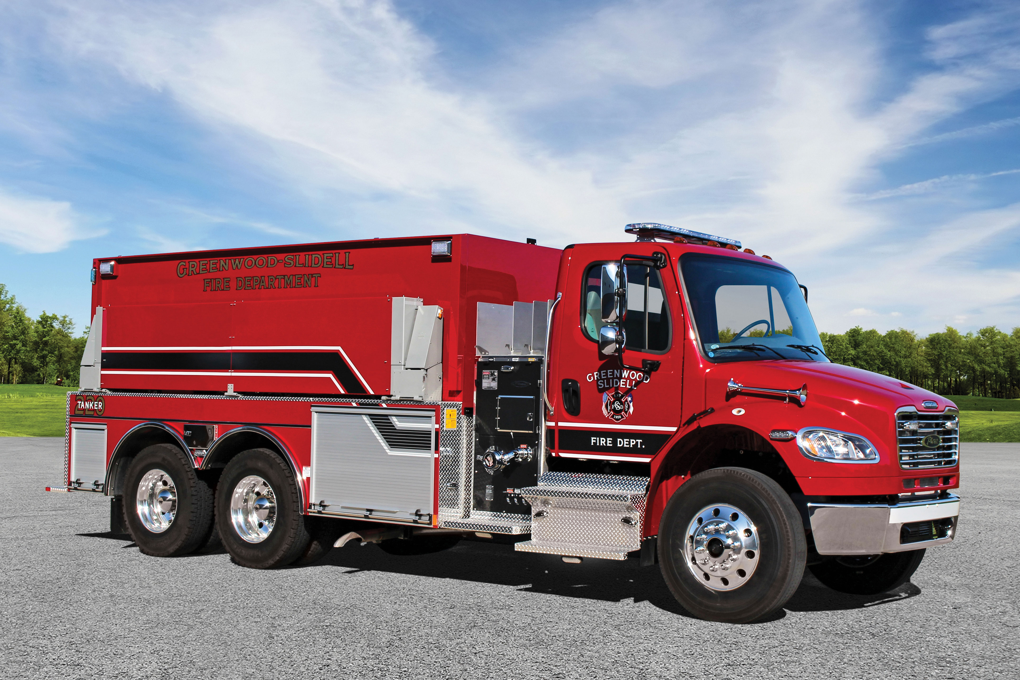 Officer’s side of a Pierce BX Tanker parked outside in a parking lot on a sunny day. 