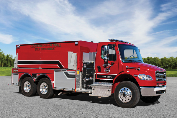 Officer’s side of a Pierce BX Tanker parked outside in a parking lot on a sunny day.