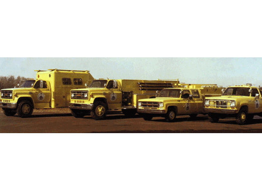 Four yellow Pierce vehicles parked outside for Saudia Arabia. 