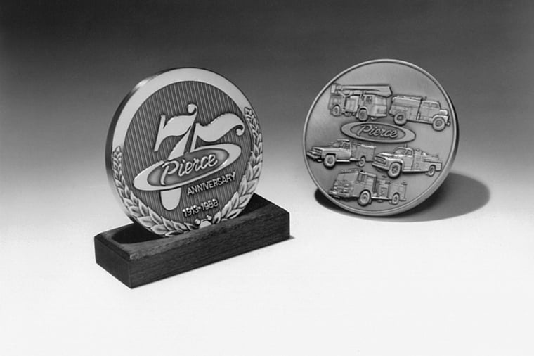 Two Pierce Manufacturing 75th Anniversary silver medallions. 