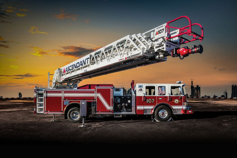 A Pierce Manufacturing Aerial Ascendant Ladder raised into the air at sunset. 