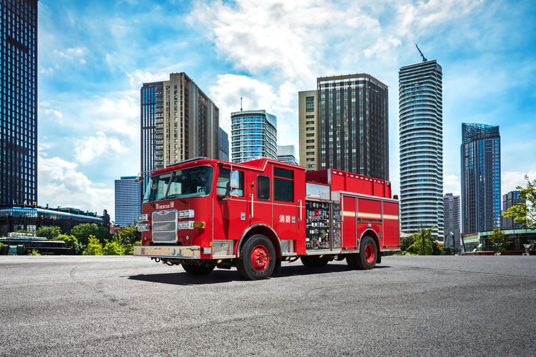 Pierce Ultra Highrise Pumper parked outside on a sunny day surrounded by buildings.
