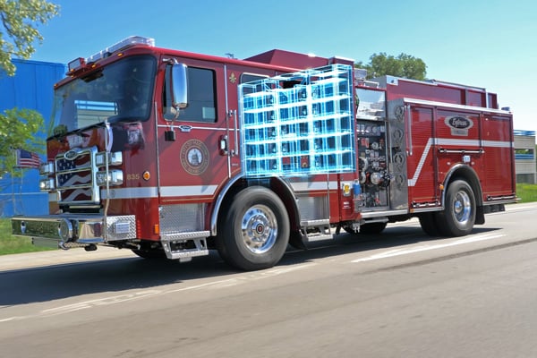 Pierce Volterra electric fire truck driving down the road showing its internal onboard battery system. 