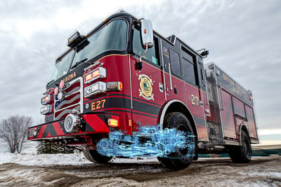 A red fire truck with a blue suspension system overlay graphic drives on a wintery road.