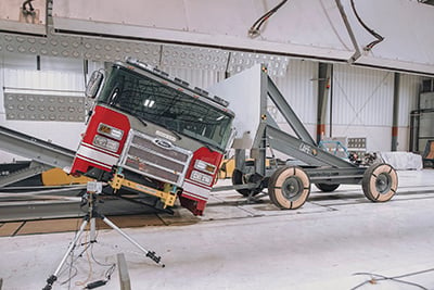 Red fire truck at an angle being safety tested