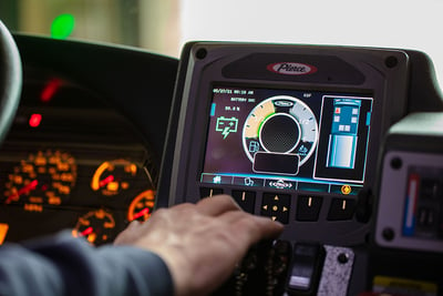 A touchscreen inside an electric fire truck shows the battery level status.