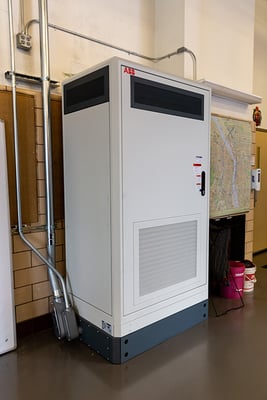 An electric vehicle charging station high voltage cabinet sits inside a fire station.