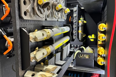 Pull out compartments from a heavy-duty rescue walk-in fire apparatus display various mounted tools and equipment.