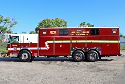 A side profile image of the red and white Prince George County Fire/EMS Department heavy-duty walk-in rescue fire truck.
