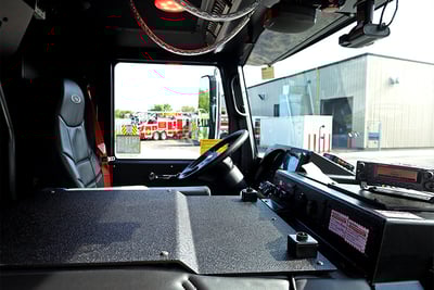 The interior of a fire truck cab shows the two-door ‘true stubby’ design. 