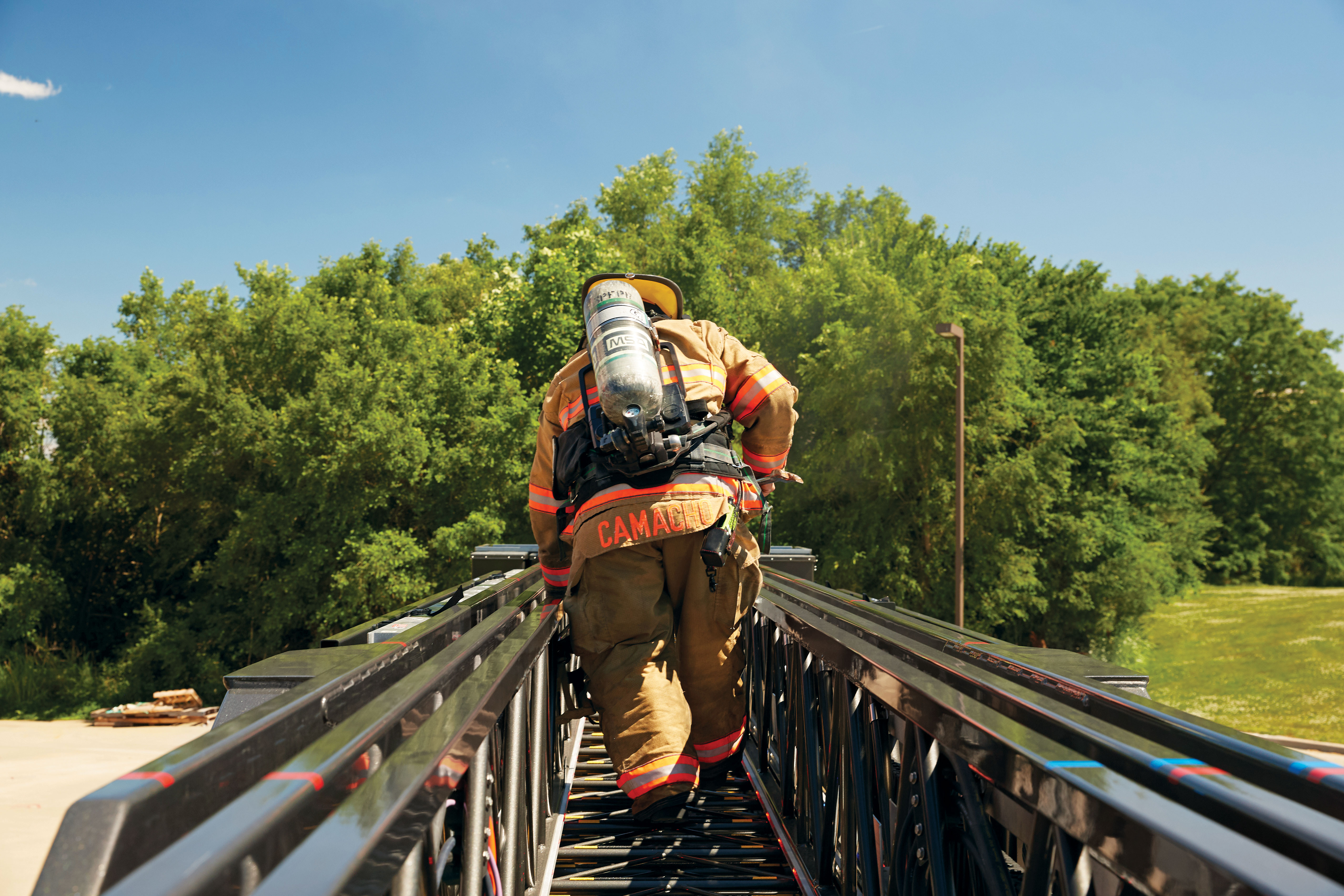 Southern Platte Fire Protection District 100' Heavy-Duty Steel Aerial Platform Fire Truck Firefighter Climbing on Ladder