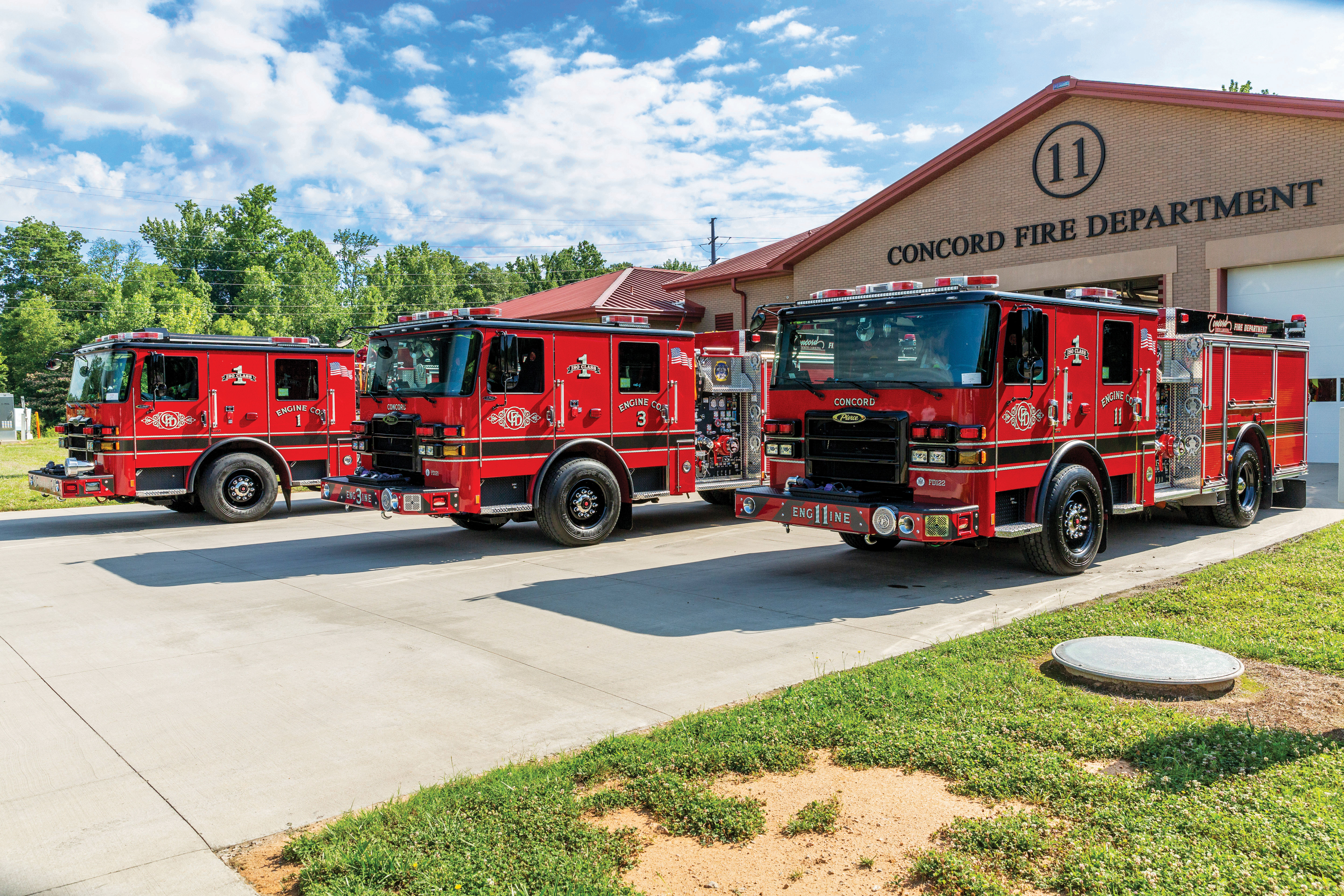 Enforcer Custom Fire Truck Chassis in Front of Fire Station