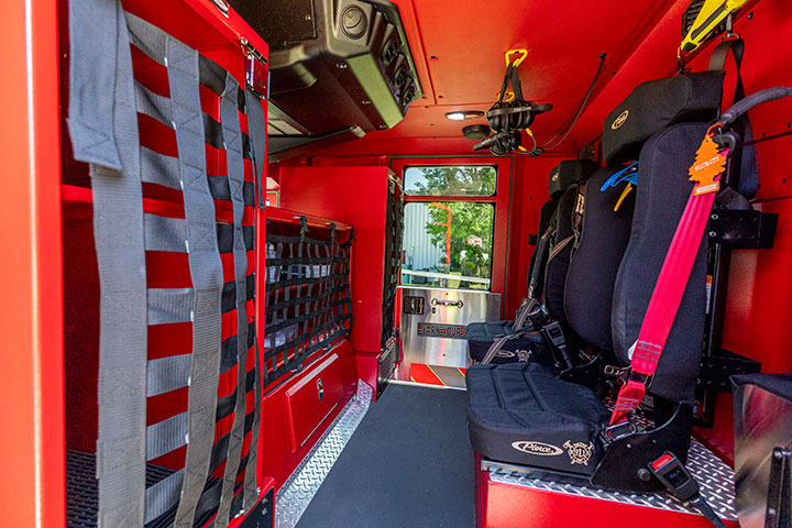 The crew cab of a Pierce Pumper showing seats and compartmentation.