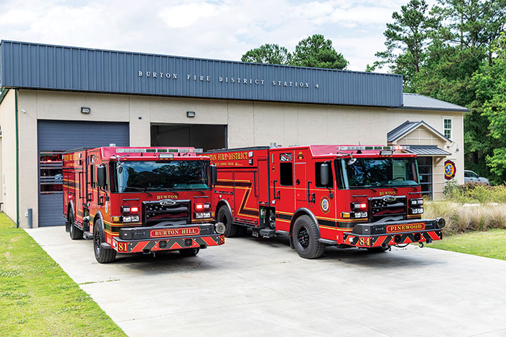 Two red Pierce Enforcer PUC Pumpers parked in front of the Burton Fire District fire station.