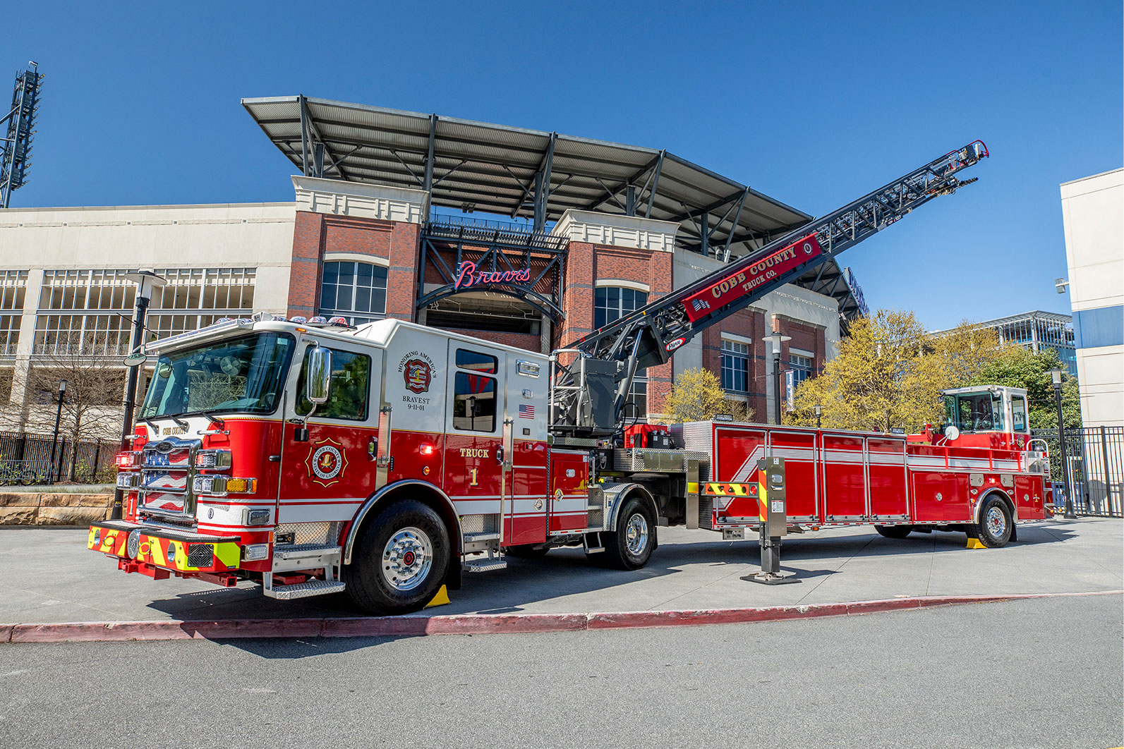 An Enforcer 107 Ascendant Heavy-Duty Tractor Drawn Aerial with the aerial up in front of the Braves stadium.