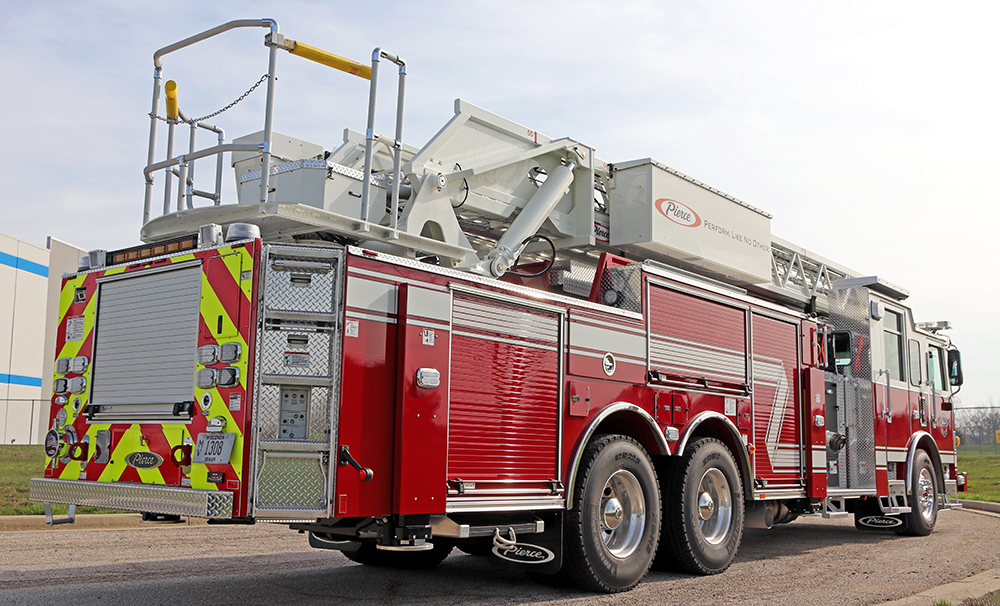 Angled rear view of a red and white Pierce 100' Heavy-Duty Low Profile Steel Aerial Ladder truck.