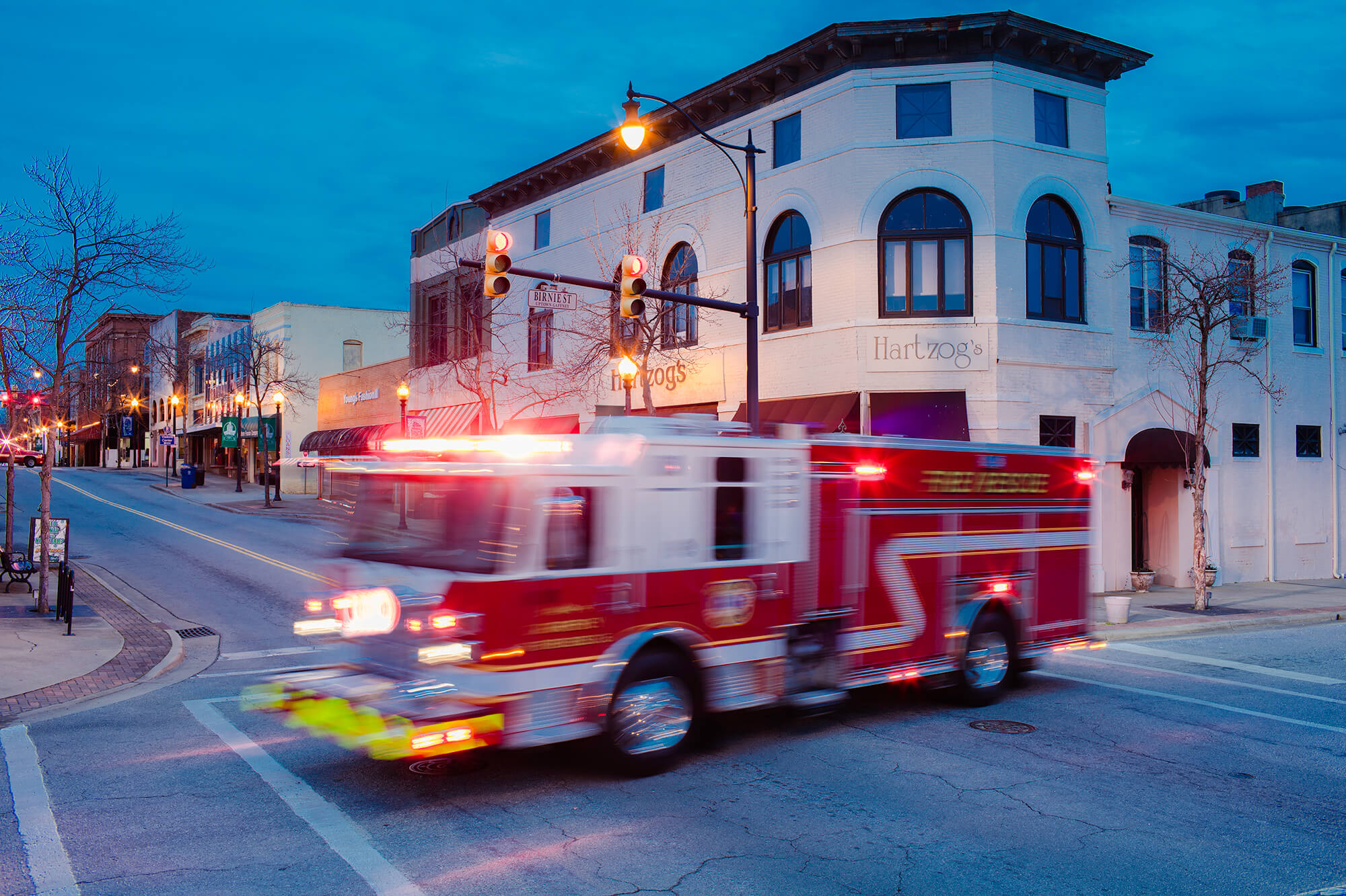 Fire Truck Responding to Call With Emergency Lights Flashing Going Through Intersection