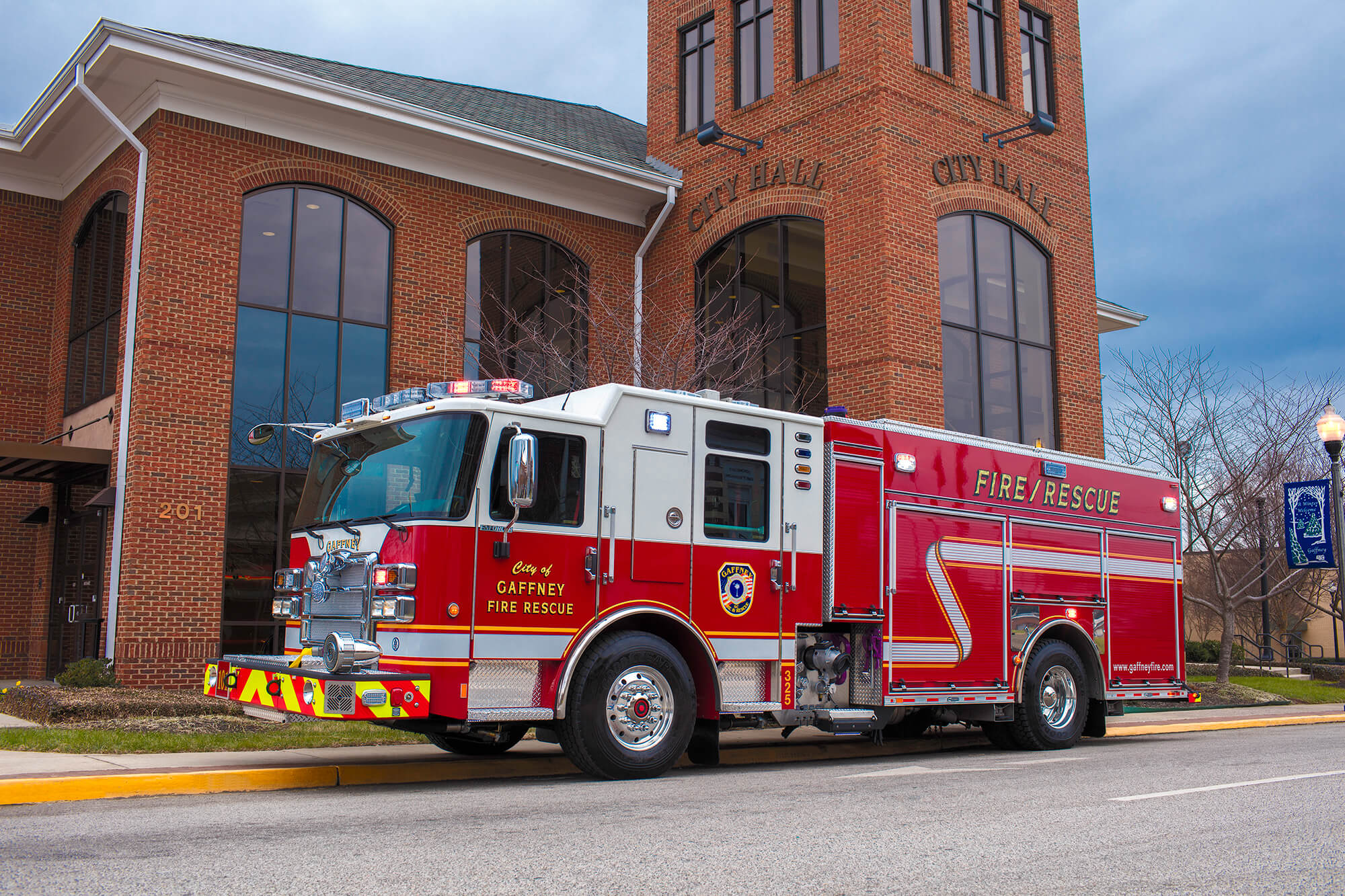 Pumper Fire Truck Drivers Side Parked in Front of Fire Station